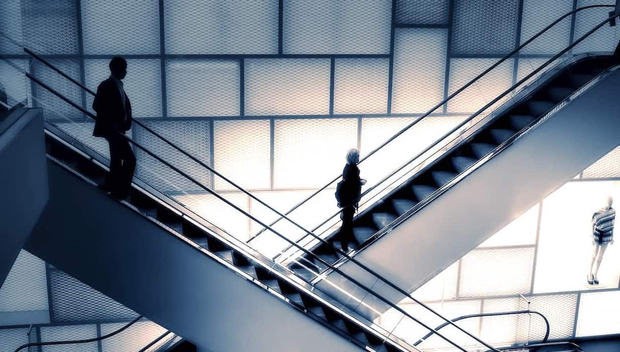 Up and down escalators illustrating the difference between de-escalate and deescalate. Up and down escalators illustrating the difference between de-escalate and deescalate.